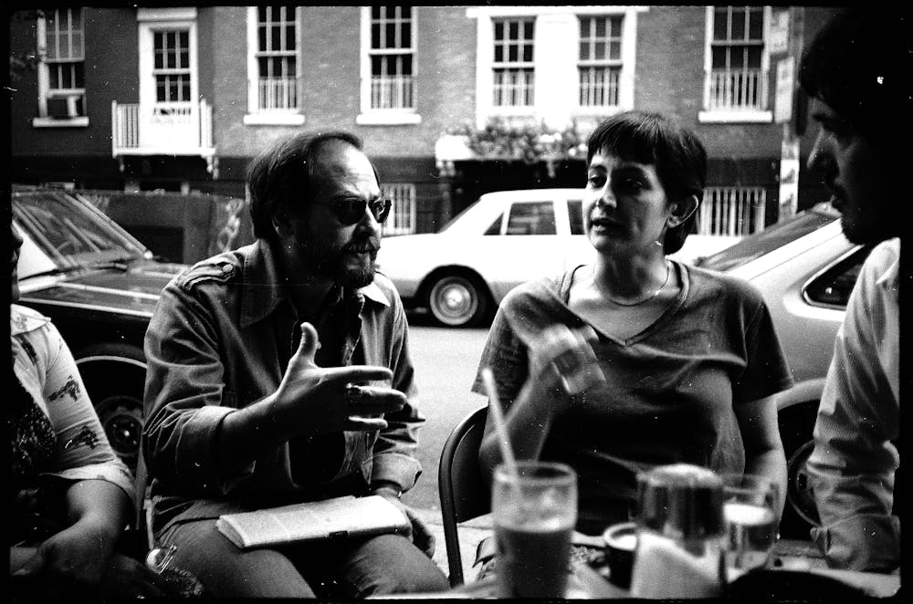 a group of people sitting in front of a building