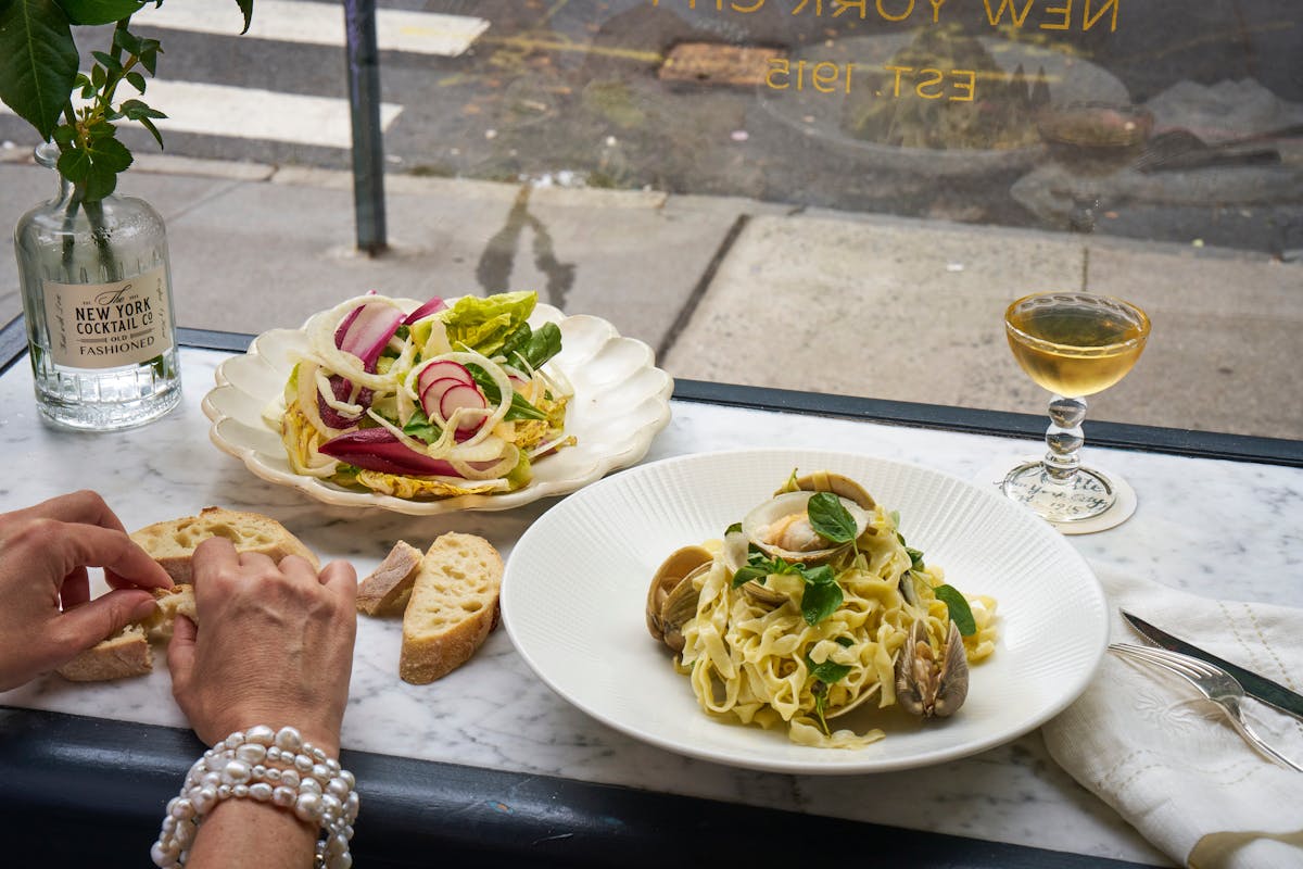 a plate of food with a glass of wine
