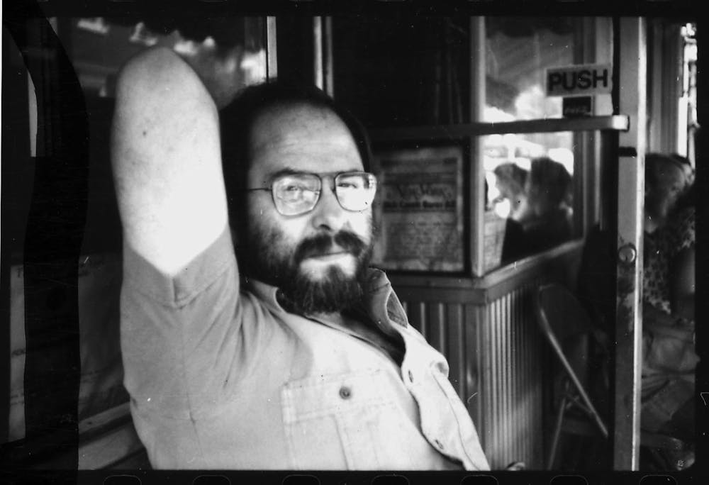 a man in glasses looking at the camera