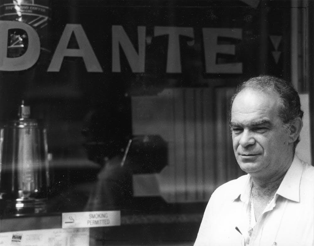 a man standing in front of a restaurant