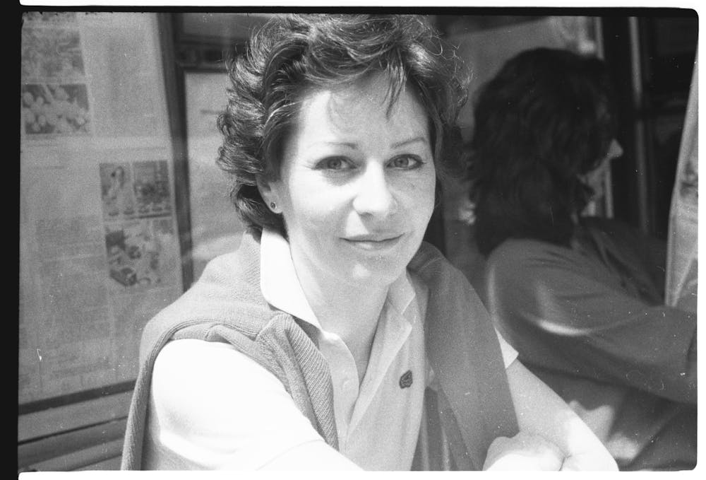 a woman standing in front of a mirror posing for the camera