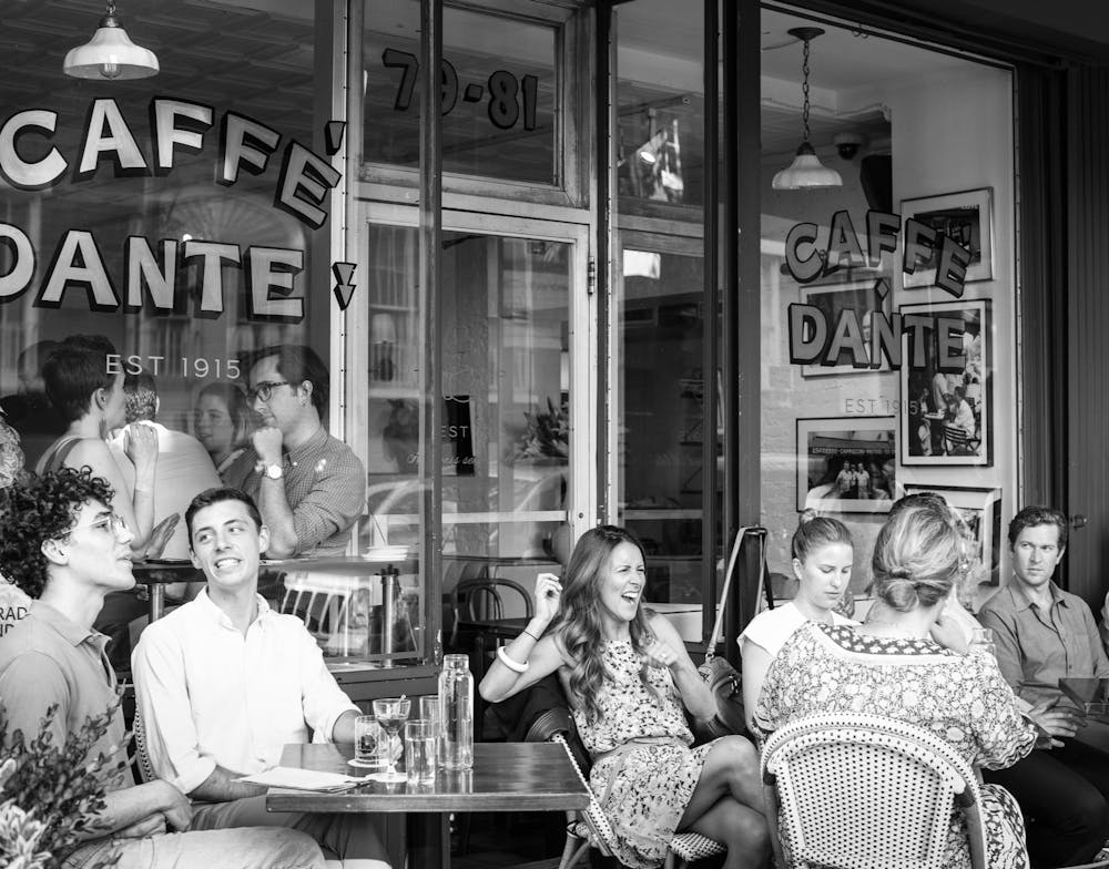 Rafael da Silva Nascimento et al. sitting in front of a store